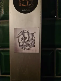 Street sticker A black and white illustration of a boot with a sword piercing it. The text around the boot says "AKERSBRGA" and at the bottom "HAR FOR A HARML."