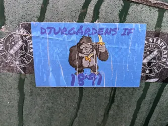 Street sticker A blue sticker featuring a cartoon gorilla holding two bananas. The text "DJURGARDENS IF" and "1891" is visible. The sticker shows some signs of wear and tear.