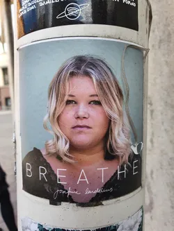 Street sticker A sticker featuring a portrait of Josfine Landelius with the word "BREATHE" written underneath. The sticker has a light teal background and appears to be promoting her music.