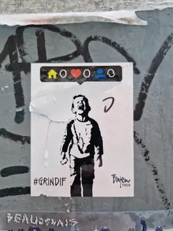Street sticker A sticker featuring a stencil-like illustration of a child screaming.  At the top are small icons resembling those found on social media platforms (home, heart, etc.).  The text '#GrindIf' is visible at the bottom left, and 'Bajen Tribe' is at the bottom right. The sticker appears to be affixed to a wall with graffiti.