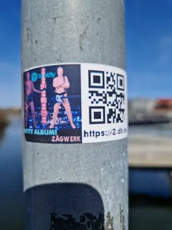 Street sticker Sticker promoting a new album release by Zagwerk, featuring a QR code linking to a website and Spotify logo.