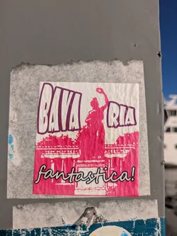 This sticker features a striking design with a pink and white color scheme. It depicts a statue silhouette against a building backdrop. The text "BAVARIA" is boldly printed above the image, and the word "fantastica!" is at the bottom.