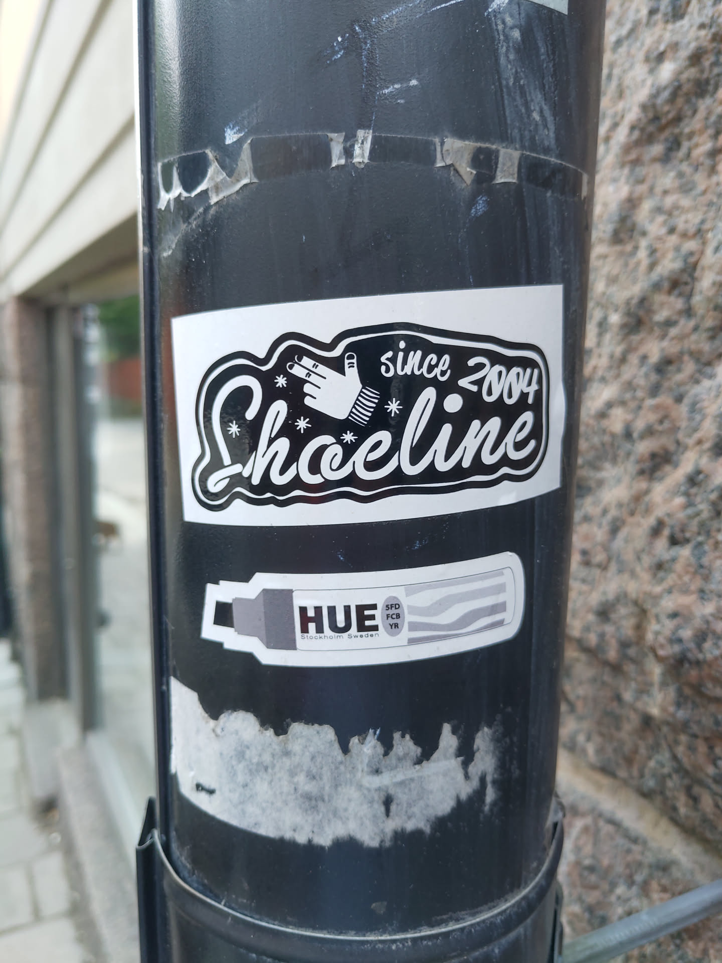 Black and white sticker with the text "Shoeline since 2004" and a hand graphic. There is also a smaller sticker underneath advertising HUE markers.