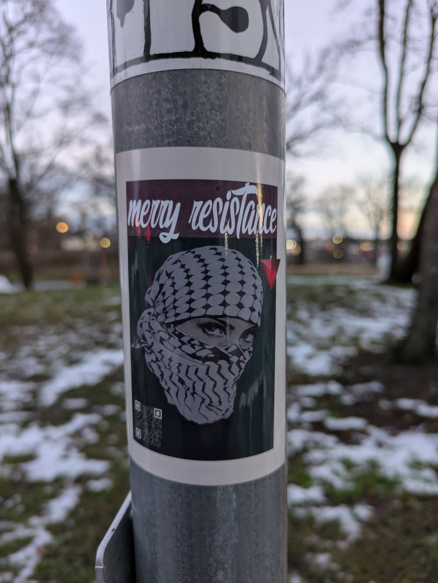 Sticker featuring a woman wearing a keffiyeh, with the text "Merry Resistance".  The style is graphic and impactful.
