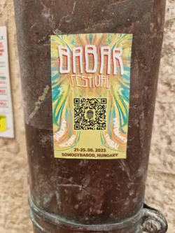 Sticker for the Babar Festival in Somogybabod, Hungary.  The design features a colorful abstract background with the festival name and dates. A QR code is included for easy access to more information.