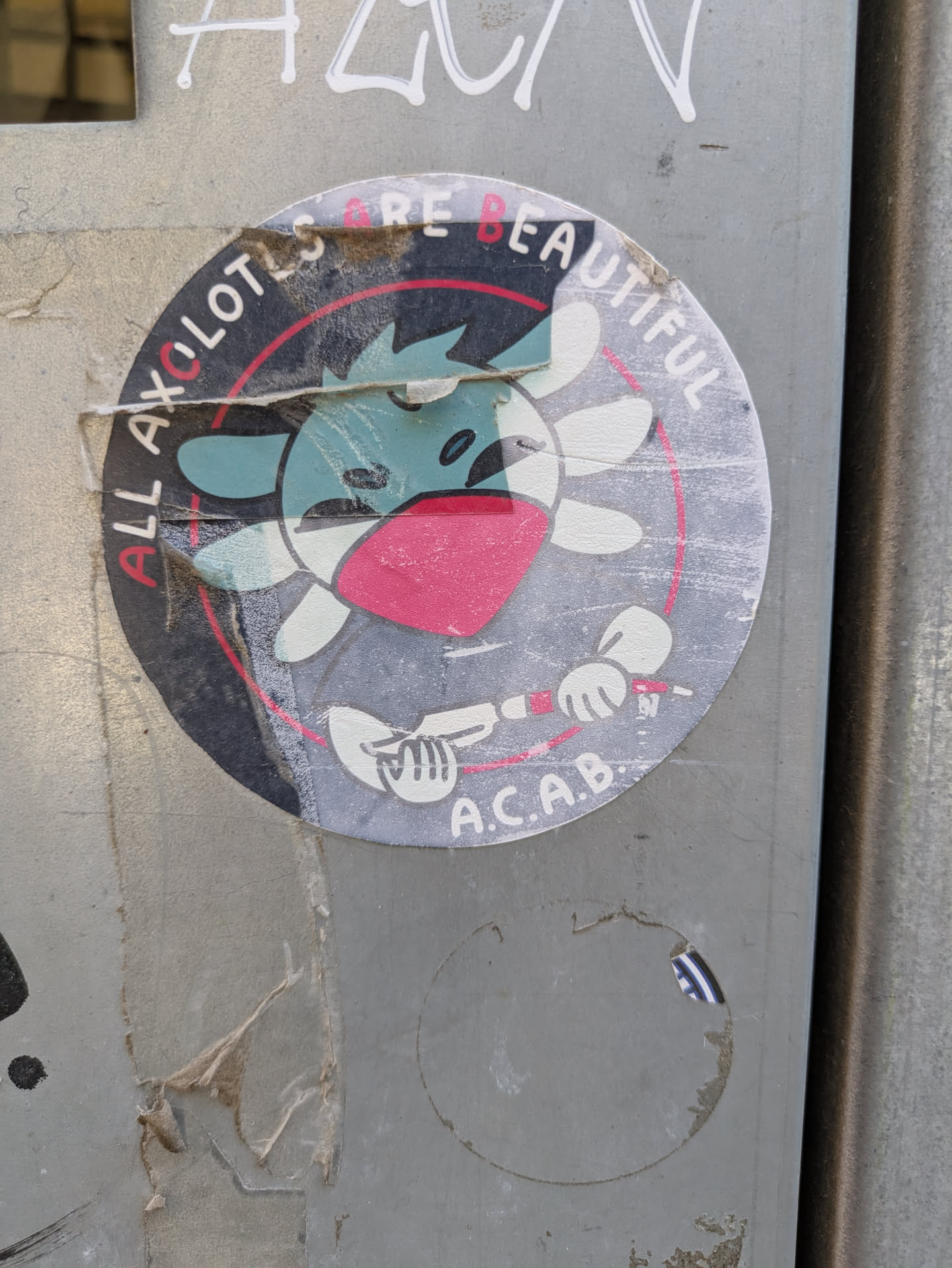 A round sticker featuring a cartoon axolotl with a red mask, inside a circle with the text 'ALL AXOLOTLS ARE BEAUTIFUL' and 'A.C.A.B.' at the bottom.