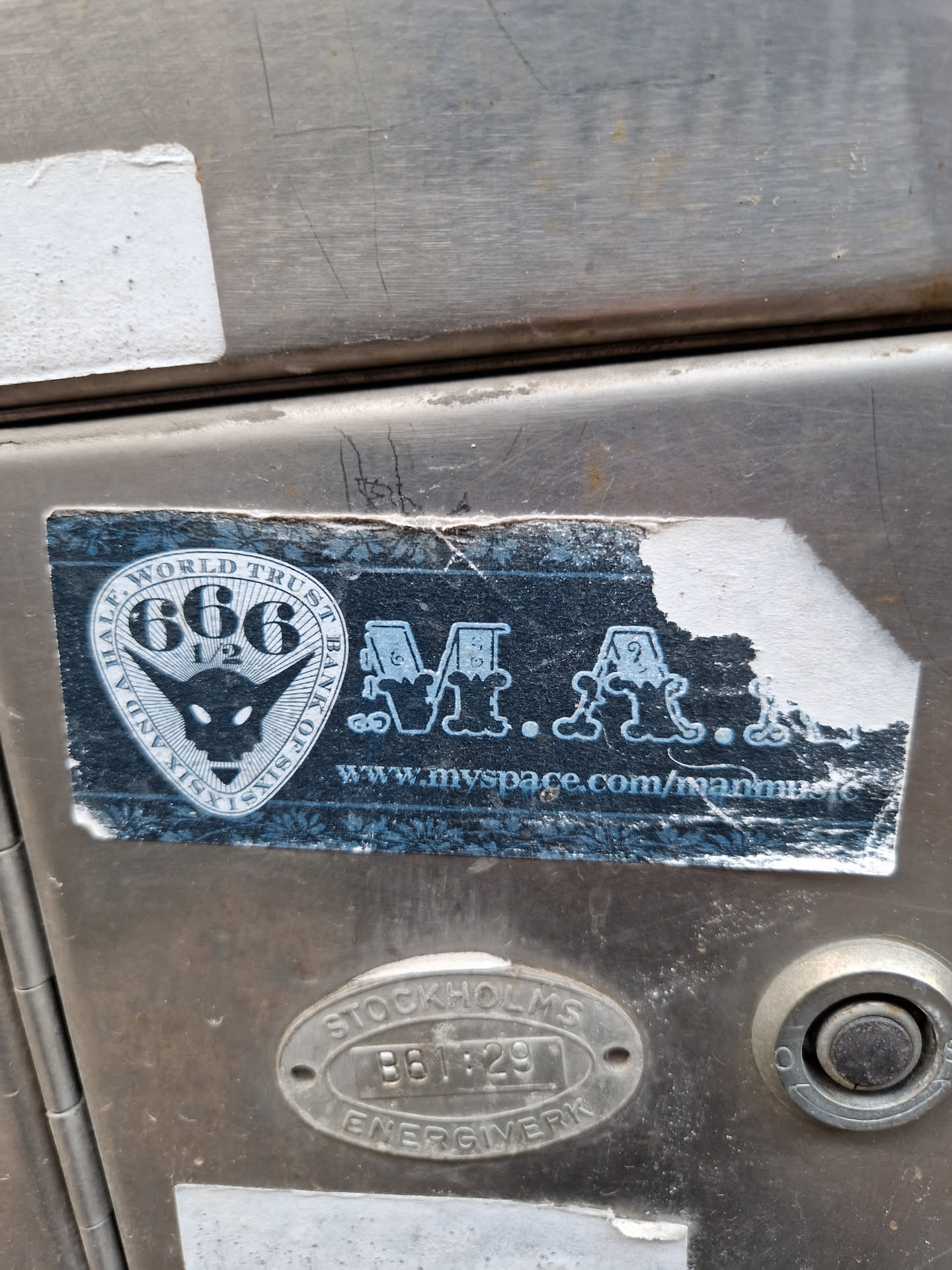 A sticker with a logo that says "Half World Think Tank 666" and features a goat-like figure. It includes a website address: www.myspace.com/manunmc.