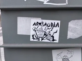 Black and white illustration sticker featuring a stylized face surrounded by abstract shapes and the word "Artsaudia".