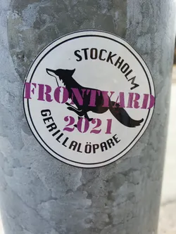 A round sticker featuring a running fox illustration and text. The text includes 'Frontyard', 'Stockholm', 'Guerilla Löpare', and '2021'. The style is minimalist with a monochrome palette.
