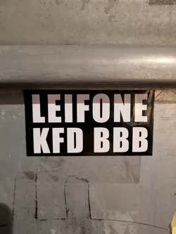 The sticker is rectangular with a black background and white text. The text is LEIFONE on the top line and KFD BBB on the bottom line.