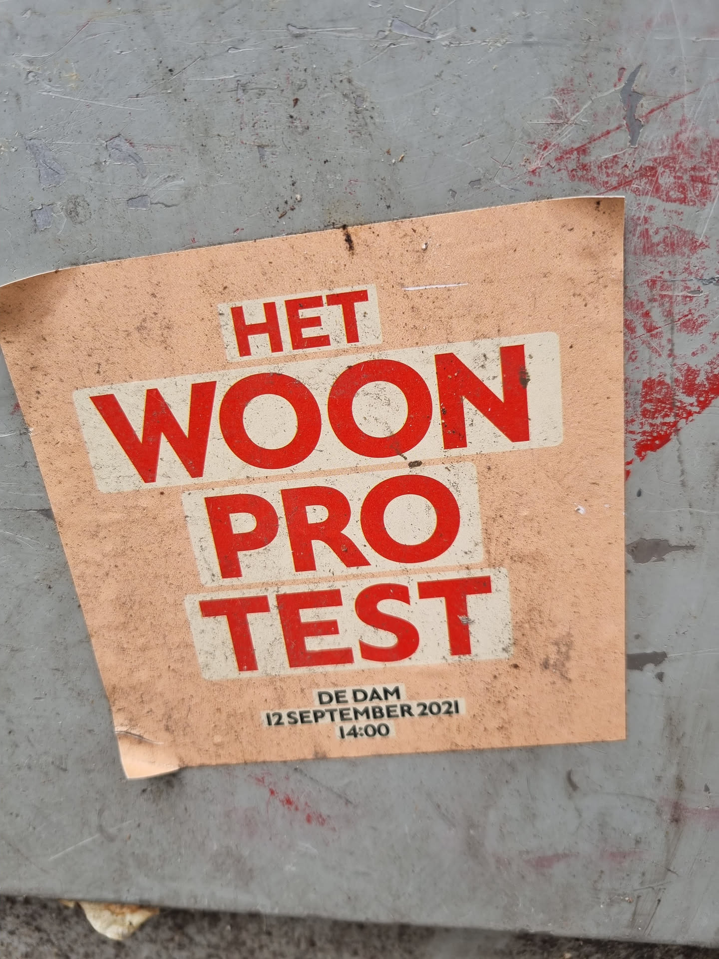 A sticker announcing a housing protest at De Dam in Amsterdam on September 12, 2021 at 2 PM.