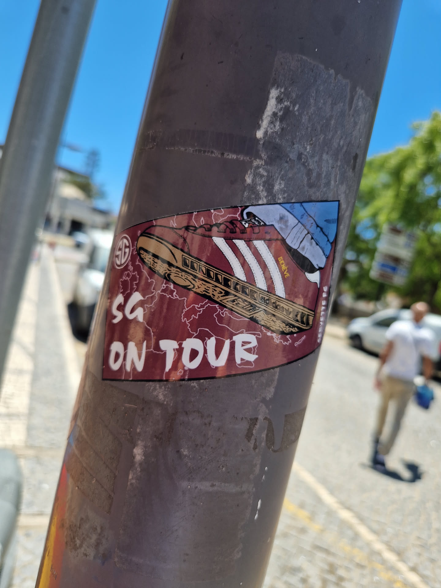 A sticker featuring a burgundy Adidas sneaker with white stripes, accompanied by a map graphic and the text 'SG ON TOUR'.