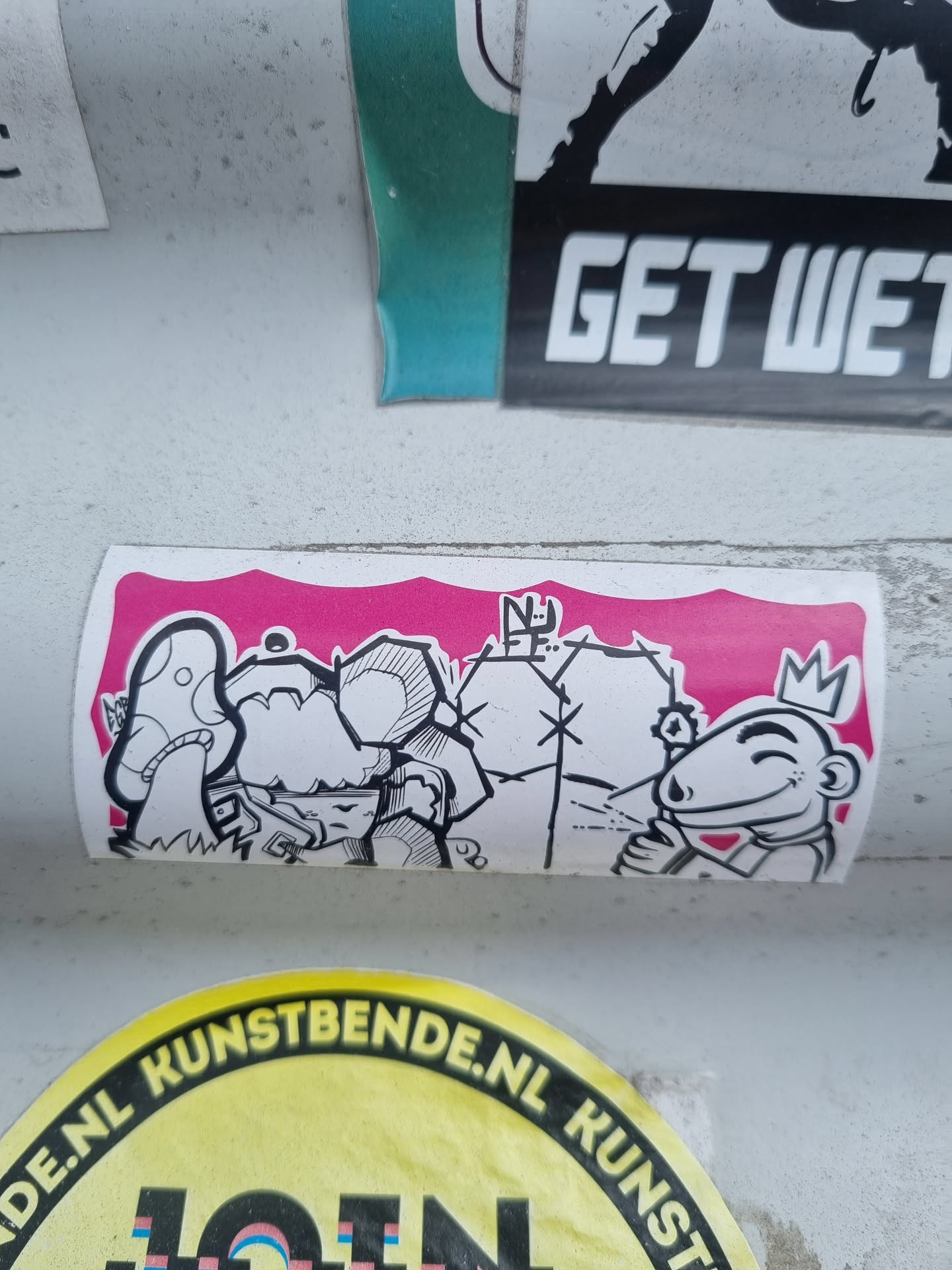This sticker shows a cartoon-like illustration of two characters on a pink background. One character wears a crown and has a sly expression, while the other has a mushroom-like appearance. The style is reminiscent of graffiti art. 