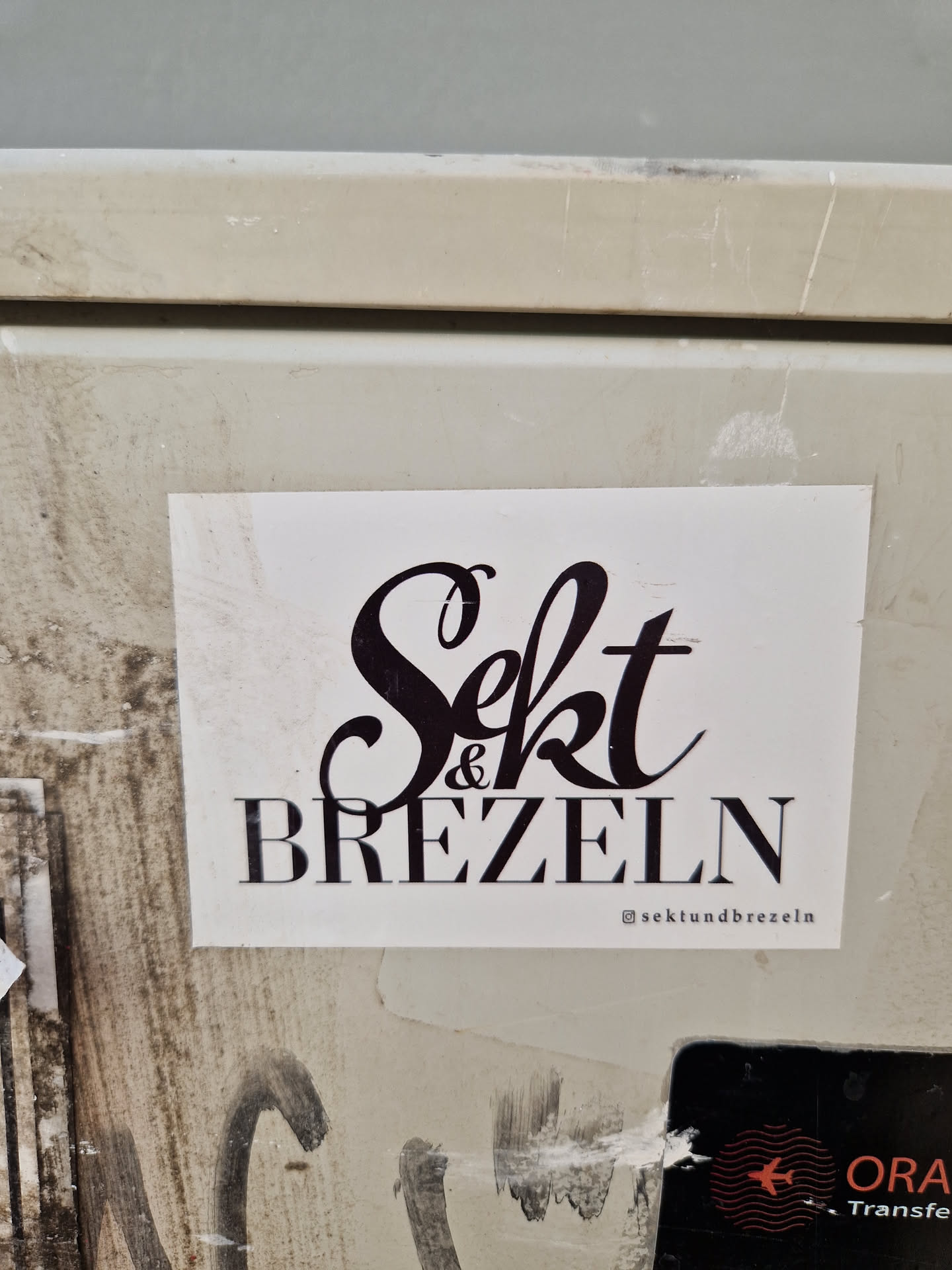 A sticker with the text "Sekt & Brezeln" in a stylized font. The Instagram handle @sektundbrezeln is also visible at the bottom of the sticker.