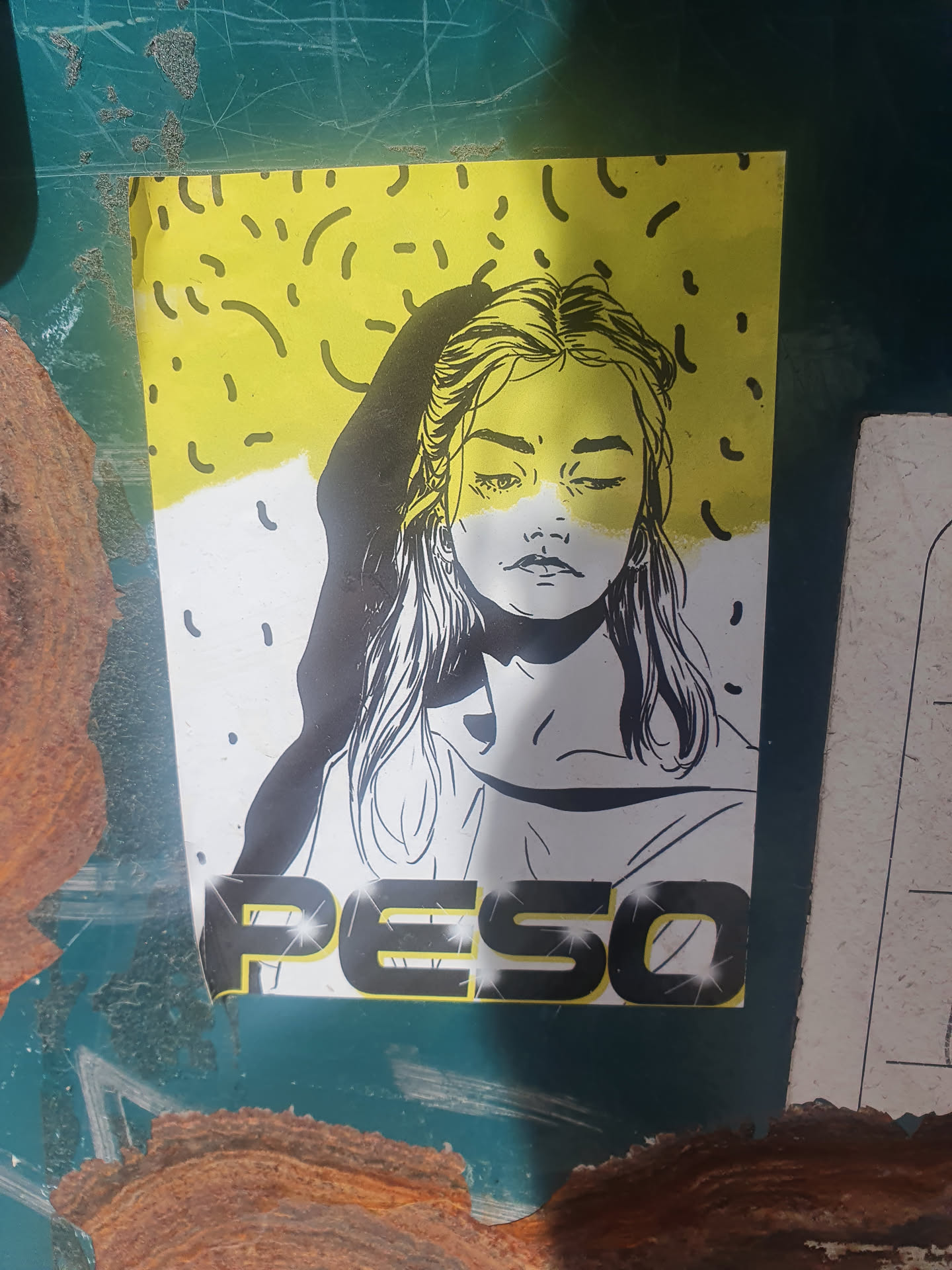 A sticker featuring a stylized illustration of a girl's face in black and white with a yellow background. The word PESO is written at the bottom in a bold, stylized font.