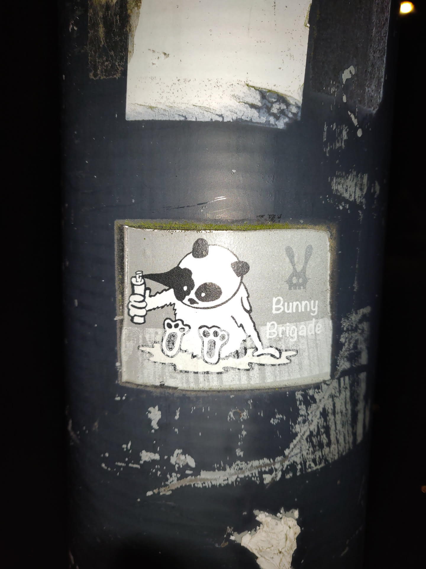 A sticker featuring a panda character from the Bunny Brigade, seemingly enjoying a drink. The art style is simple and cute, with a black and white color scheme.