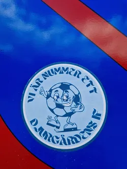 A round sticker featuring a cartoon soccer ball character with the text "Vär Nummer Ett Djurgårdens IF" which translates to "Our Number One Djurgårdens IF" in Swedish. Djurgårdens IF is a Swedish football club.