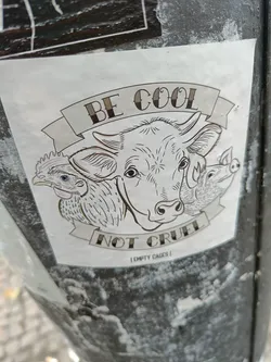 Sticker featuring a cow, chicken, and pig with the text 'Be Cool Not Cruel' and 'Empty Cages'. 