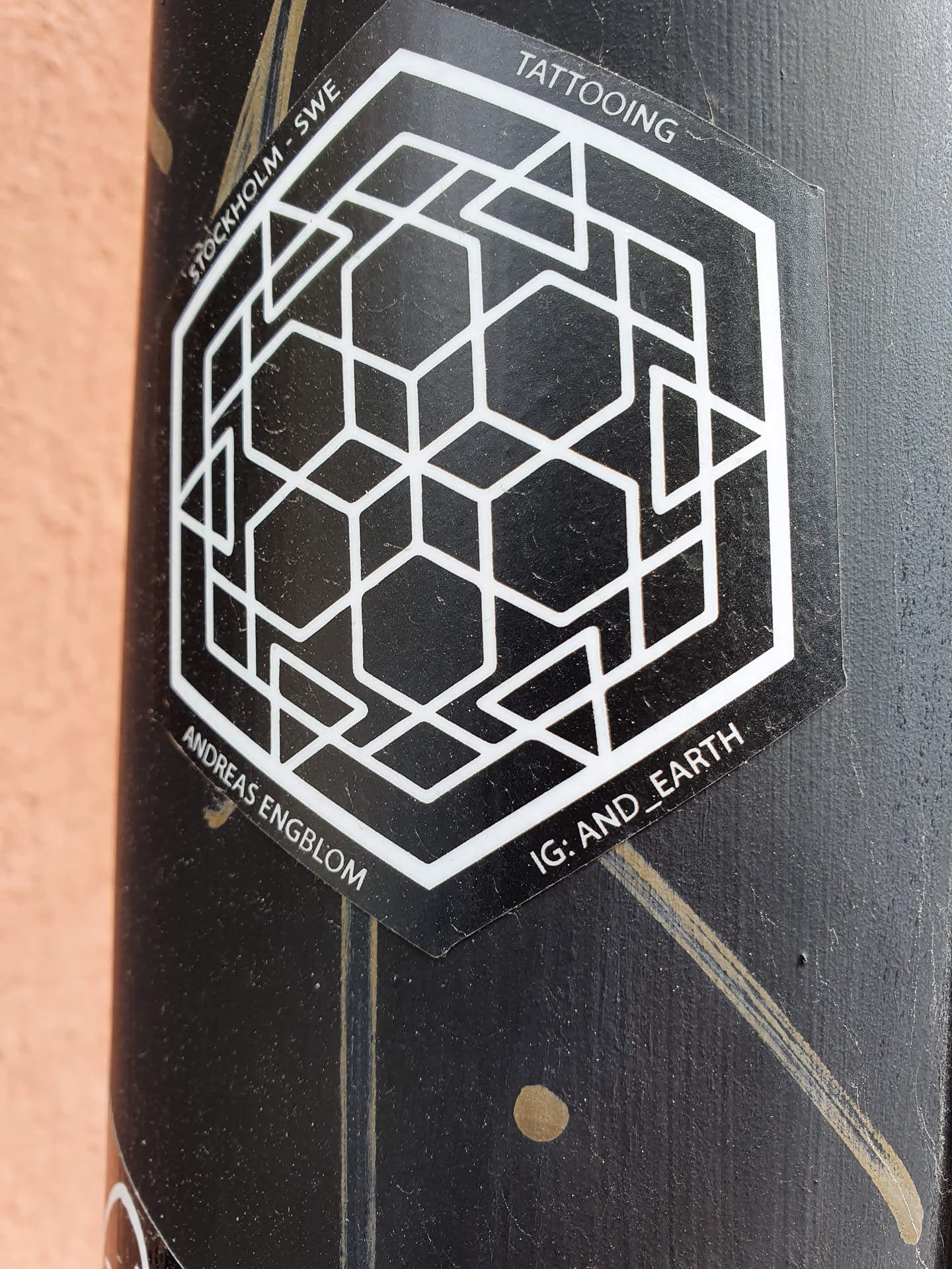 Black and white hexagonal geometric pattern tattoo design sticker.  The sticker features the artist's name and Instagram handle. 