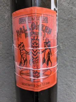 Orange sticker with black text and illustration of three cats.  The text says Sanctum Tattoo Halloween Flash Party, November 2nd 12-late.