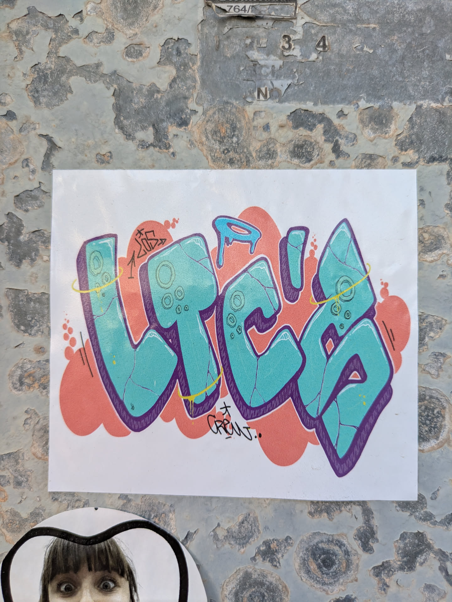 This sticker features the word 'VITA' in a vibrant graffiti style with a turquoise fill, purple outline, and coral red background. The design includes cracked texture details on the letters and playful elements like drips and embellishments.