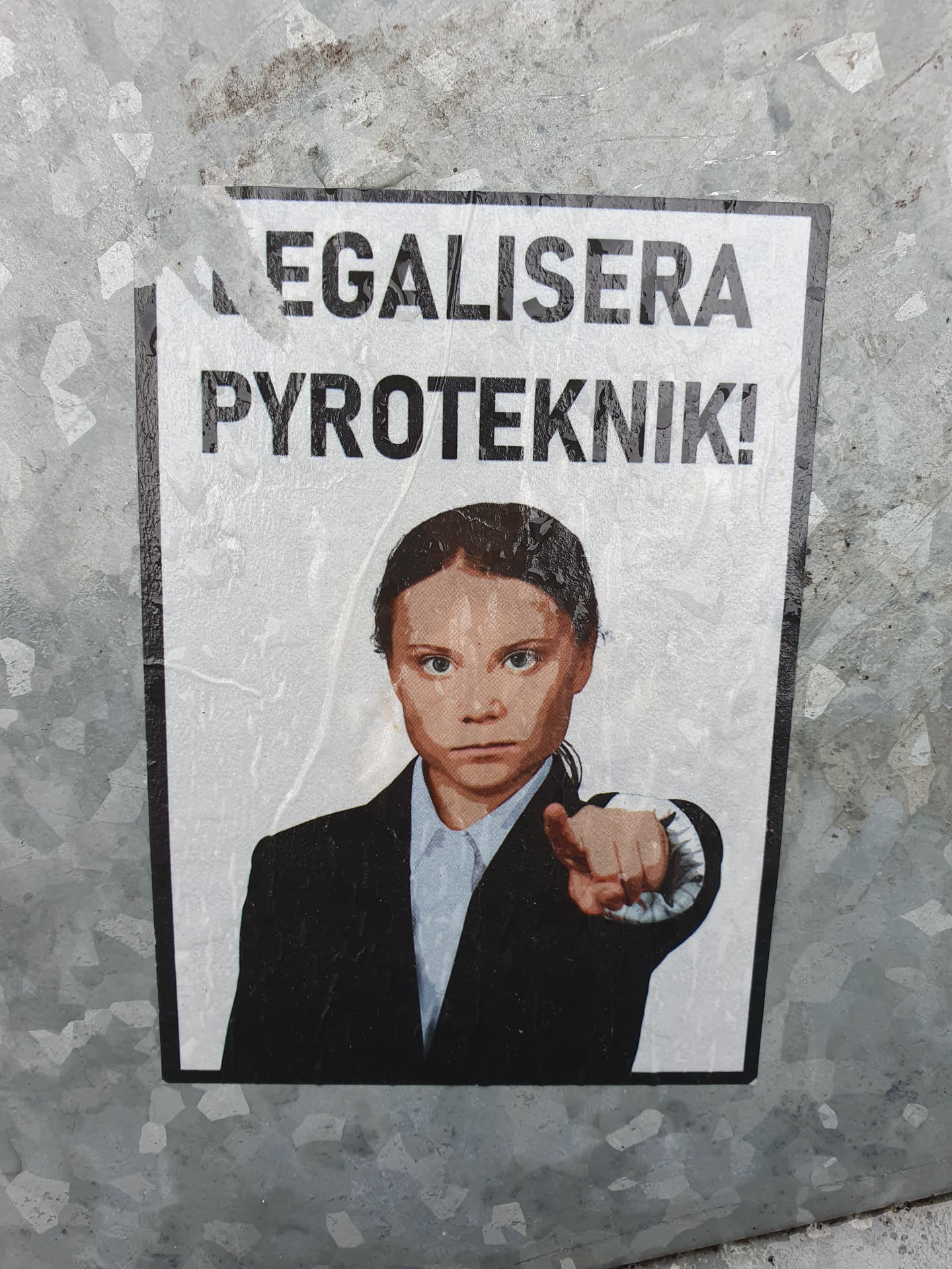 A sticker featuring Greta Thunberg pointing at the viewer with text that says "Legalisera Pyroteknik!" which translates to "Legalise Pyrotechnics!" in Swedish.