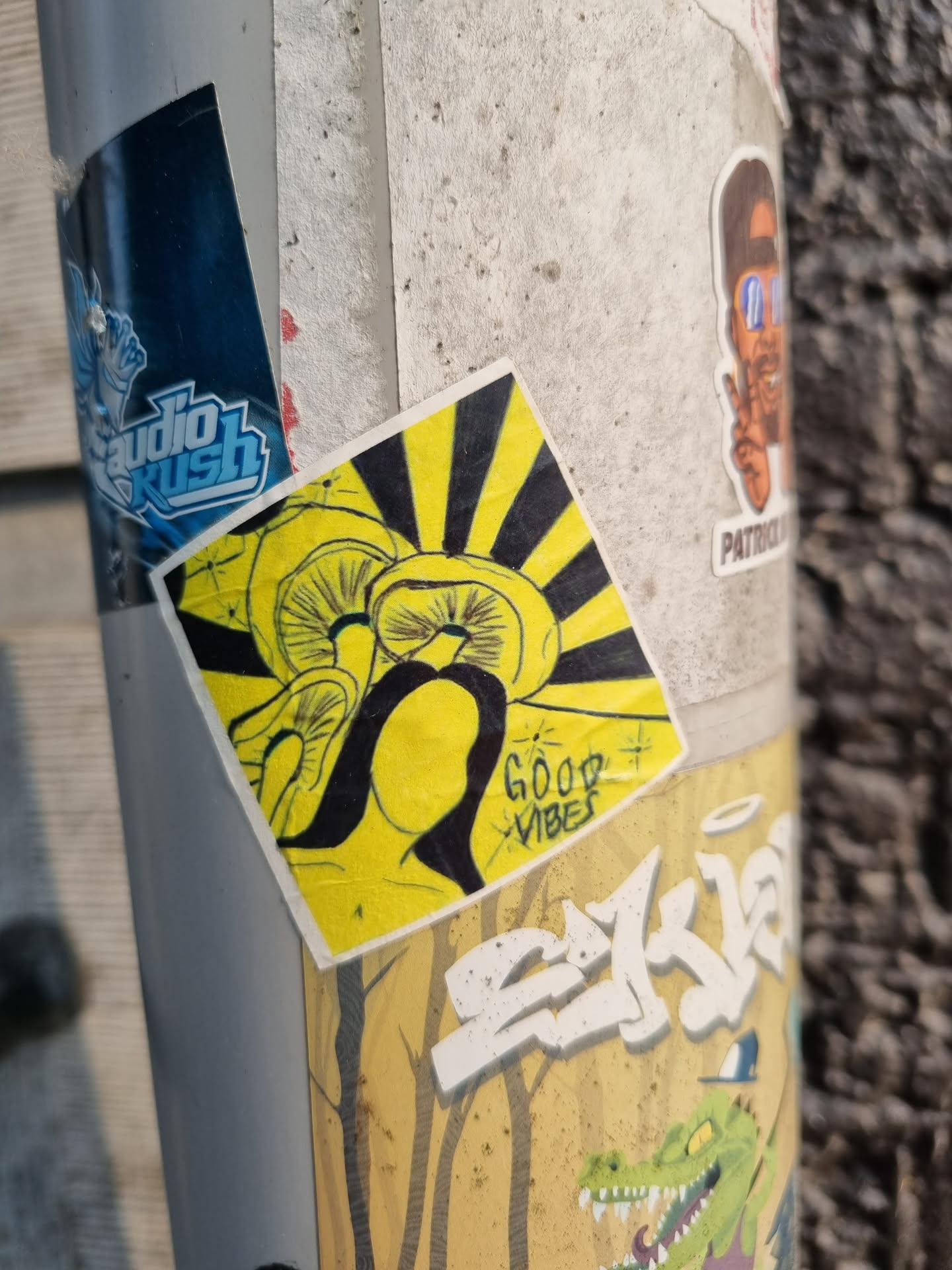 Yellow and black sticker with a design of mushrooms and sun rays. The text "Good Vibes" is written in a stylized font at the bottom.