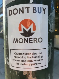 A sticker warning against Monero cryptocurrency, citing potential harm to banking systems and state apparatus.