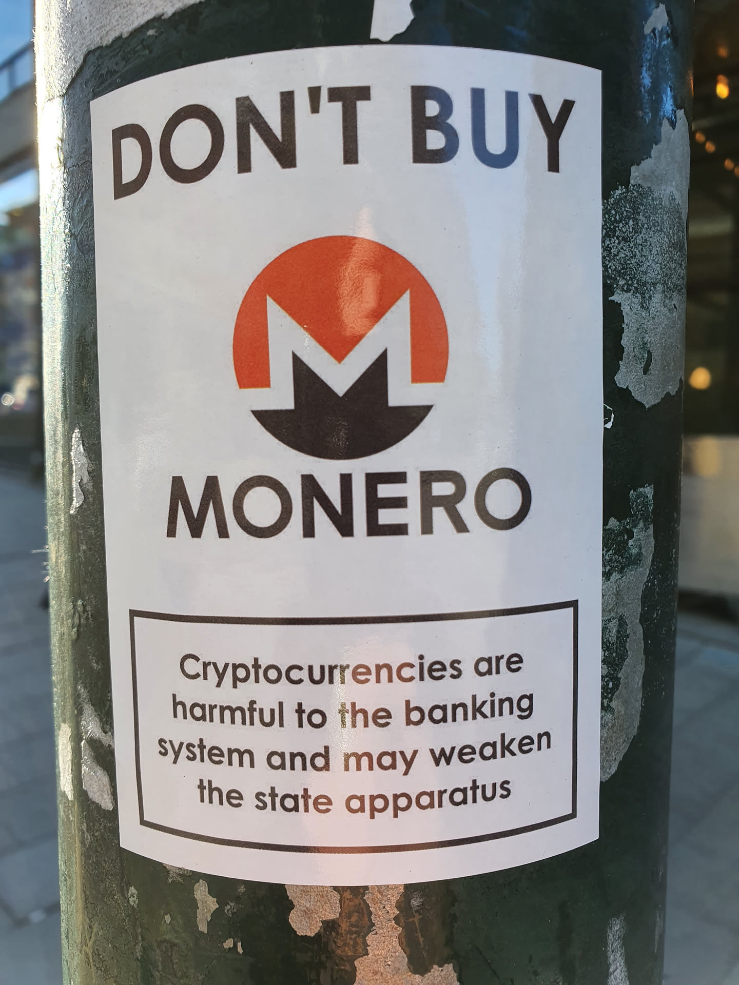 A sticker warning against Monero cryptocurrency, citing potential harm to banking systems and state apparatus.
