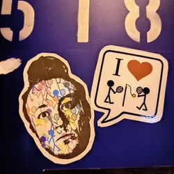 A sticker depicting a stylized portrait of a person with tennis-themed patterns covering their face, along with a speech bubble stating "I heart tennis".