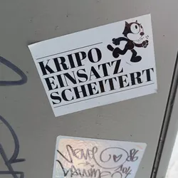 A sticker featuring Felix the Cat with the text "Kripo Einsatz Scheitert" (Criminal Police Operation Failed) in German. The sticker has a minimalist design with bold text and a simple illustration.