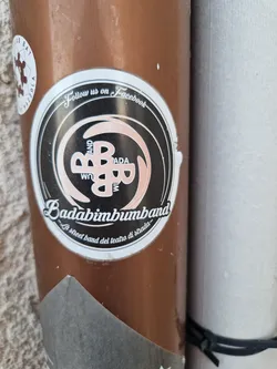 Sticker featuring the logo of Badabimbumband, a street band.  The design includes the band's name and a stylized logo. The text also includes an invitation to follow the band on Facebook.