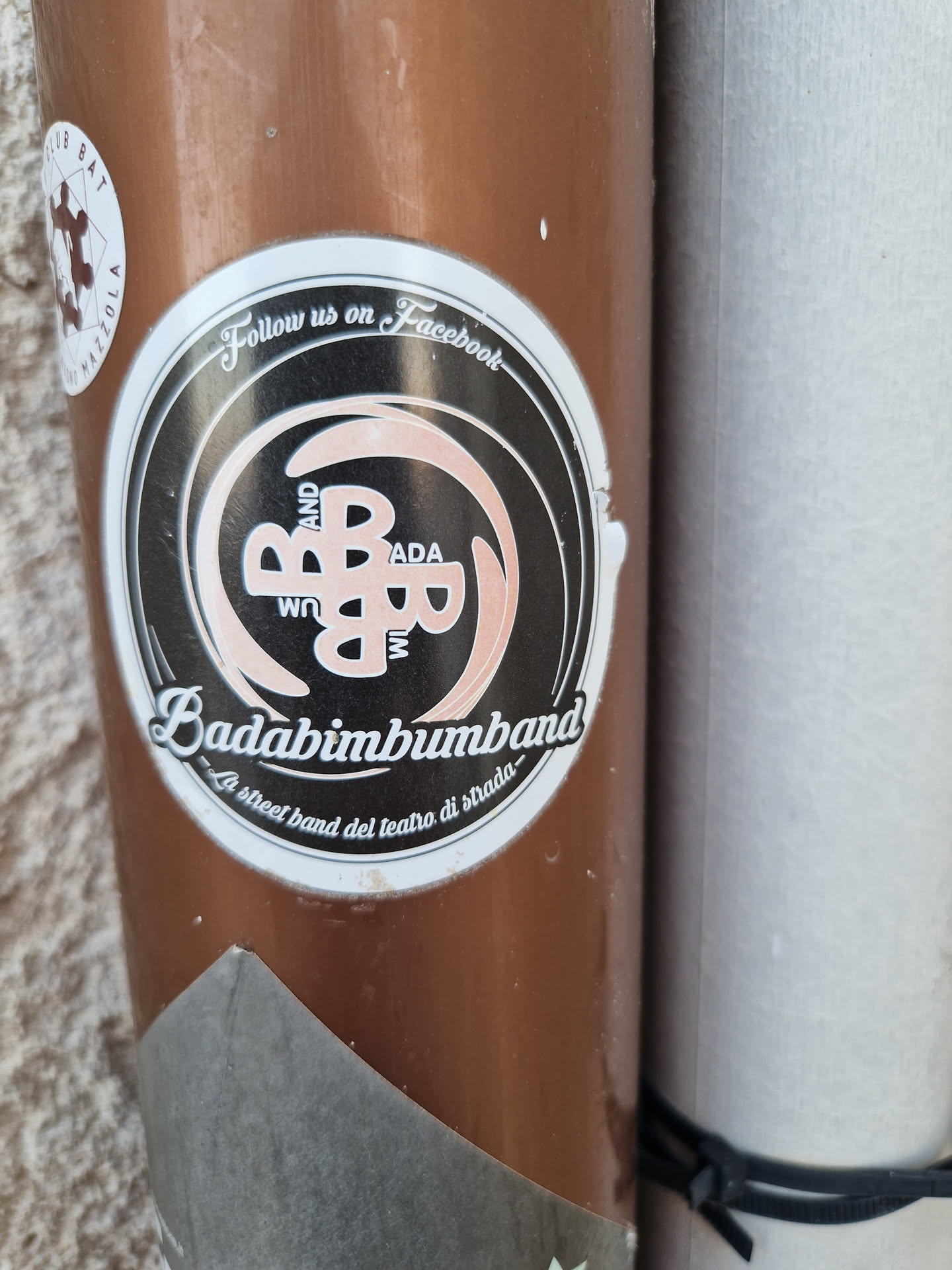 Sticker featuring the logo of Badabimbumband, a street band.  The design includes the band's name and a stylized logo. The text also includes an invitation to follow the band on Facebook.