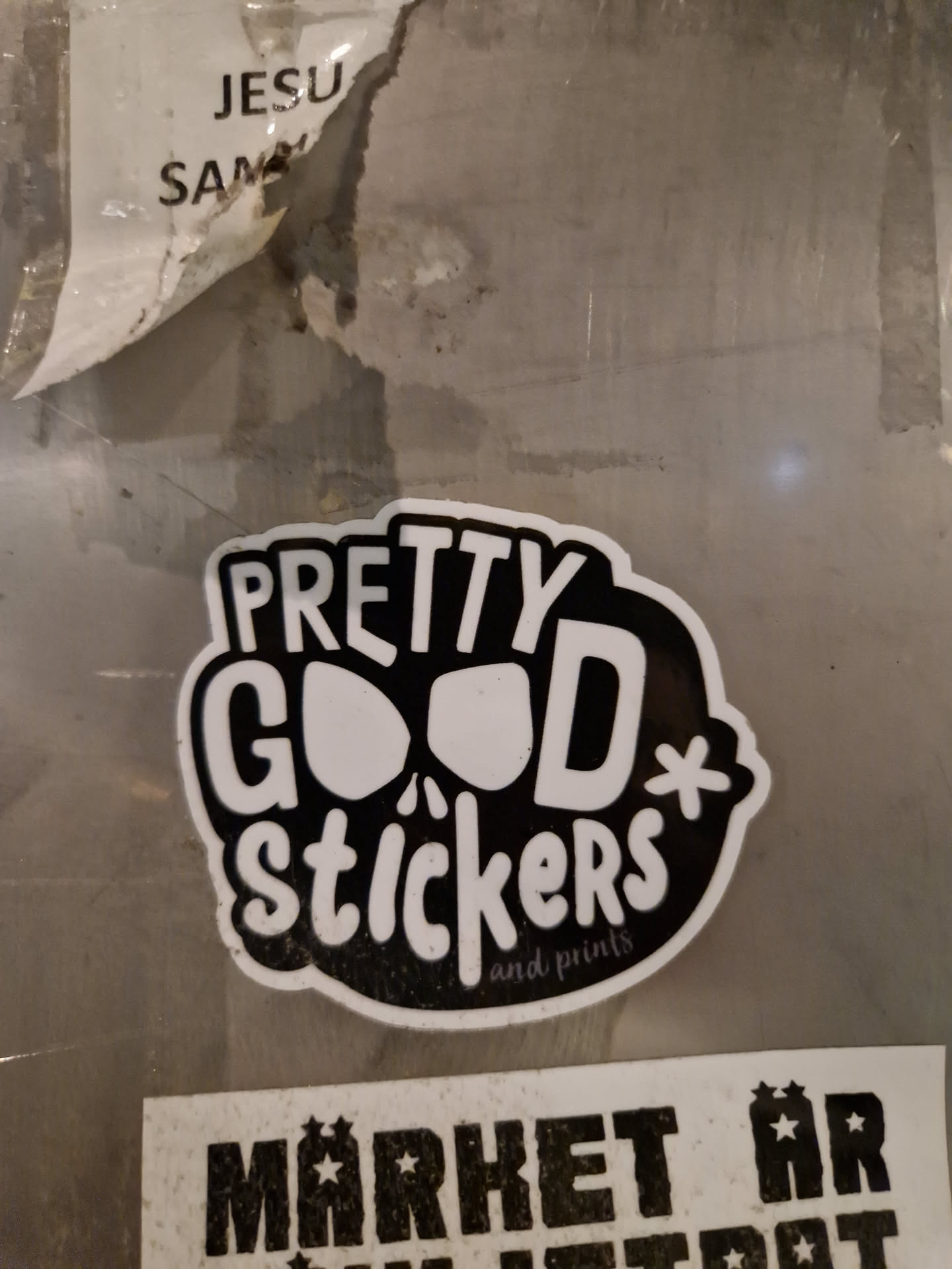 Black and white sticker with the text "Pretty Good Stickers" and "and prints" in smaller font. The style is hand-drawn with a slightly grunge aesthetic.