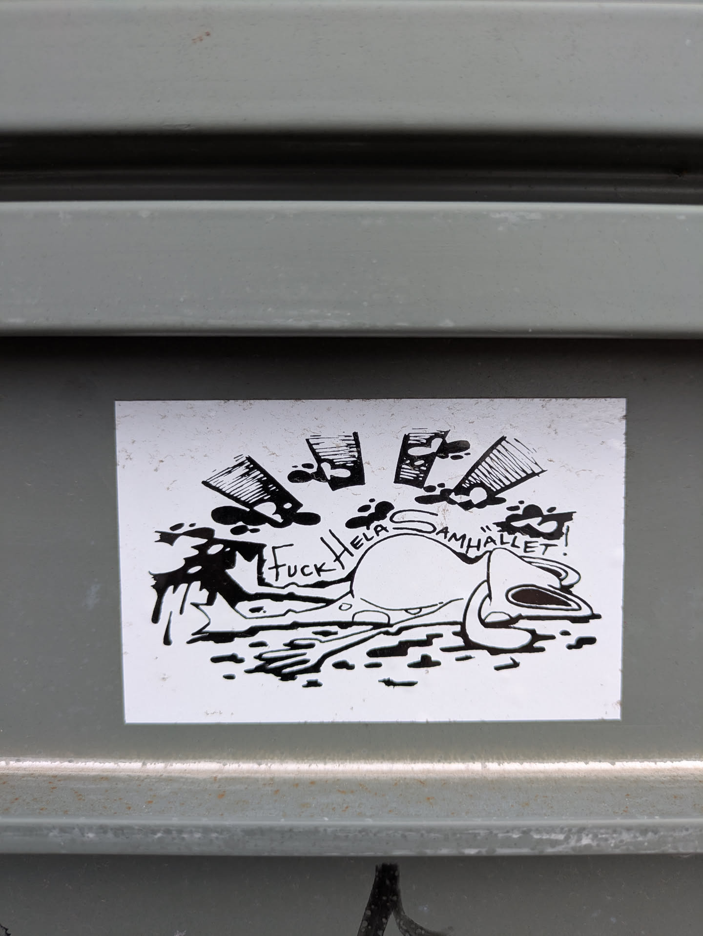 The sticker features a cartoonish, seemingly lifeless character with liquor bottles pouring out liquid. The text reads "Fuck Hela Samhället!"