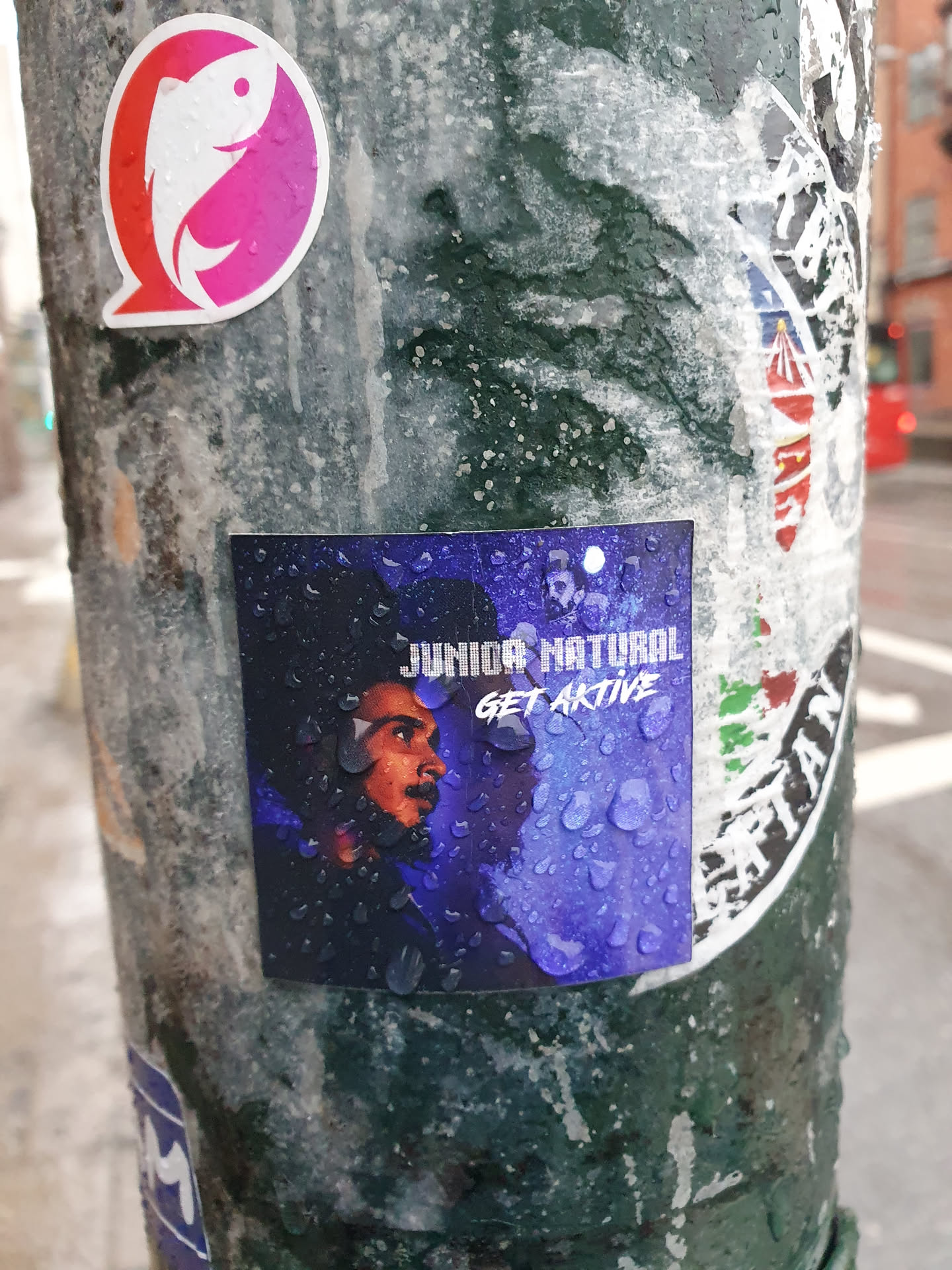 A sticker featuring Junior Natural with the text "JUNIOR NATURAL GET AKTIVE" and water droplets on it.