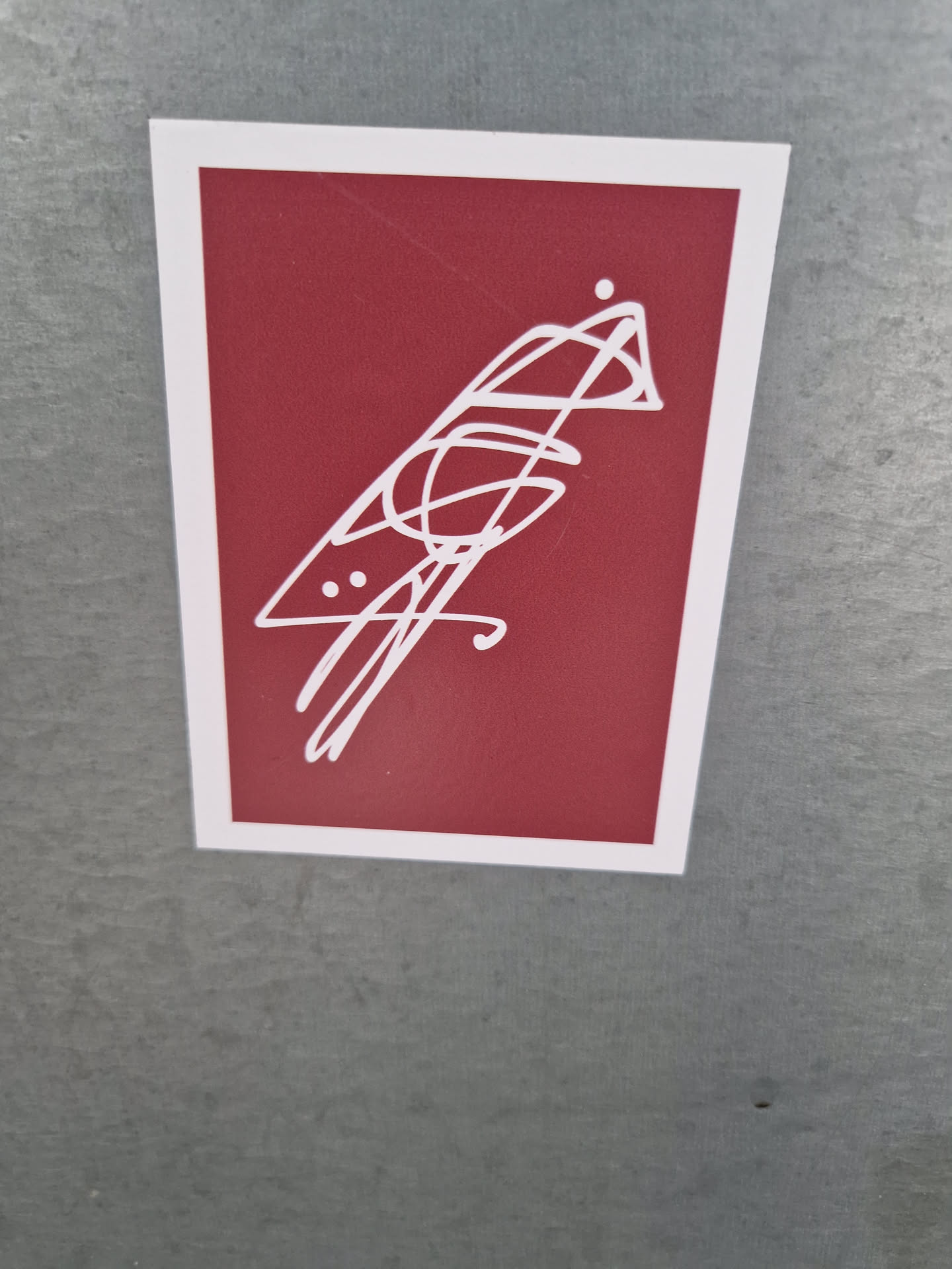 A minimalist sticker featuring a stylized bird illustration in white on a maroon background. The bird is depicted with simple lines and dots, giving it a modern and abstract feel. 