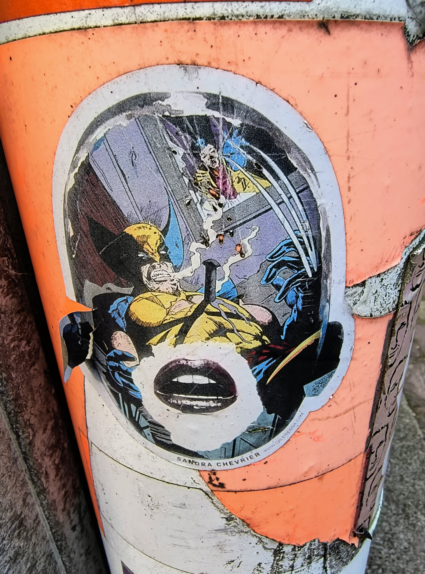 The sticker shows Wolverine in a comic book style, with a pair of lips added over the face. The sticker is on a peach-colored object.