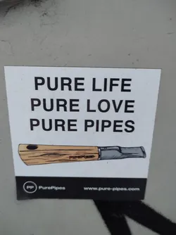 A sticker featuring a drawing of a wooden pipe and the text 'Pure Life Pure Love Pure Pipes'.  It also includes a logo and website address for PurePipes.
