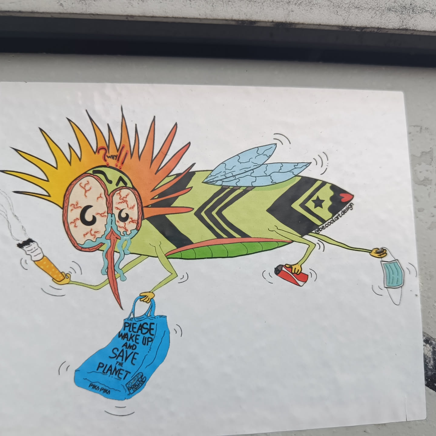 A sticker featuring a cartoon fly with a distressed expression, carrying a shopping bag and various items like a cigarette and a discarded mask. The fly's design incorporates vibrant colors and patterns, with the text on the bag advocating for environmental awareness.