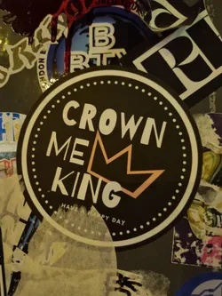 Round black and white sticker with the text CROWN ME KING and a crown graphic.  The text "HAVE A HAPPY DAY" is written at the bottom. 