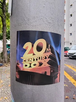 The sticker features the iconic 20th Century Fox logo. The prominent golden '20' is in the foreground, with 'CENTURY' and 'FOX' below it, also in a golden, three-dimensional font. The background depicts a starry night sky with dramatic blue and purple spotlights emanating from behind a stylized building structure, reminiscent of the classic film studio's opening sequence. A registered trademark symbol (®) is visible on the building.
