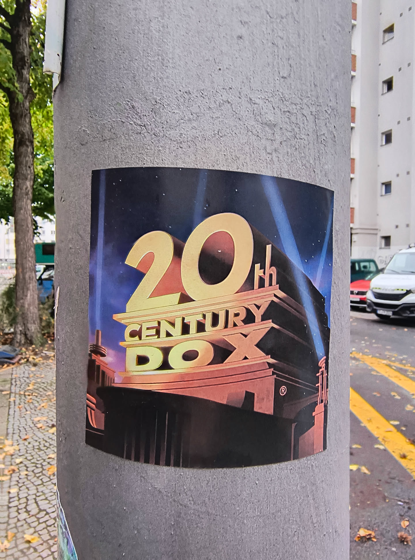 The sticker features the iconic 20th Century Fox logo. The prominent golden '20' is in the foreground, with 'CENTURY' and 'FOX' below it, also in a golden, three-dimensional font. The background depicts a starry night sky with dramatic blue and purple spotlights emanating from behind a stylized building structure, reminiscent of the classic film studio's opening sequence. A registered trademark symbol (®) is visible on the building.