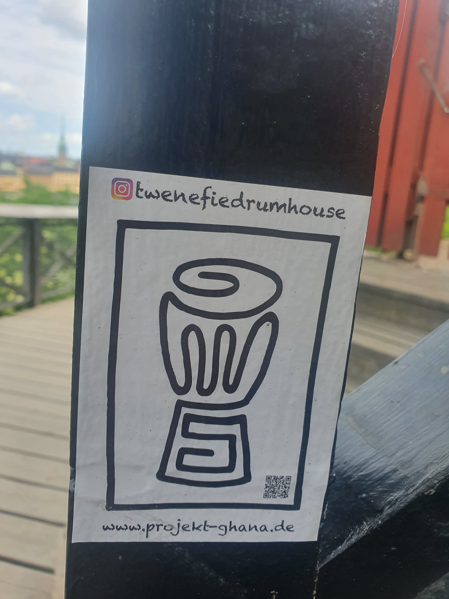 A black and white sticker with a drawing of a drum and a QR code.  It promotes Project Ghana and mentions tweneifieddrumhouse on Instagram.