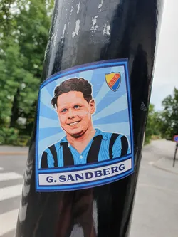 A sticker featuring a portrait of G. Sandberg, possibly a football player, with a team logo (D.I.F.) in the background. The style is reminiscent of vintage sports cards.