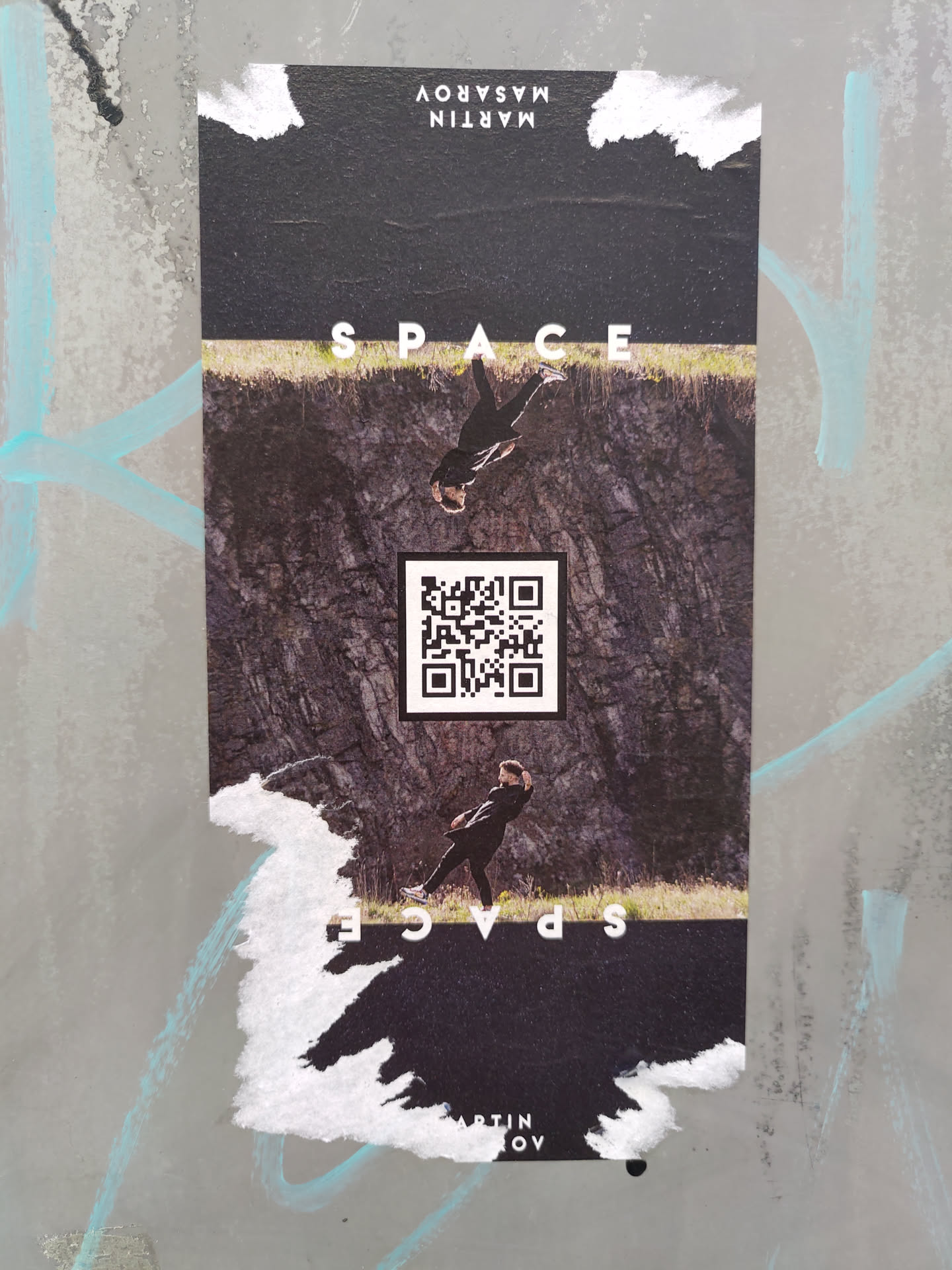 A sticker featuring a person seemingly floating in space, with the word 'SPACE' written above and below. The design is minimalistic and uses a dark color palette. It includes a QR code that likely links to the artist's website or social media.