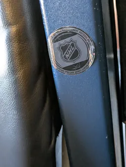 The sticker is round, with the NHL logo in the center. The text around the logo reads "NATIONAL HOCKEY LEAGUE NATIONAL HOCKEY LEAGUE".