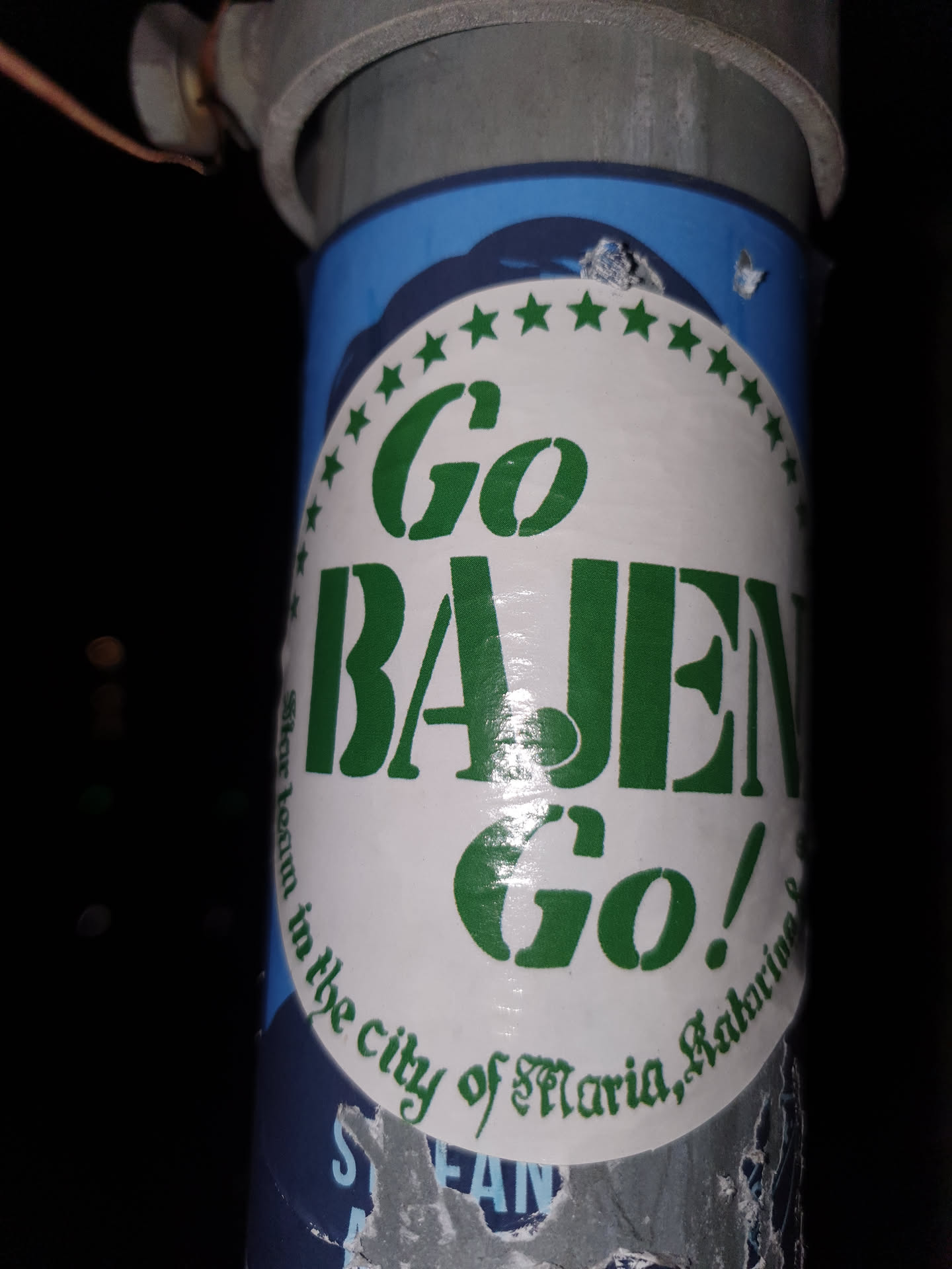 A sticker with the text "Go Bajen Go!" surrounded by a circle of stars. The text "in the city of St. Maria, Katherine" is visible at the bottom of the sticker.