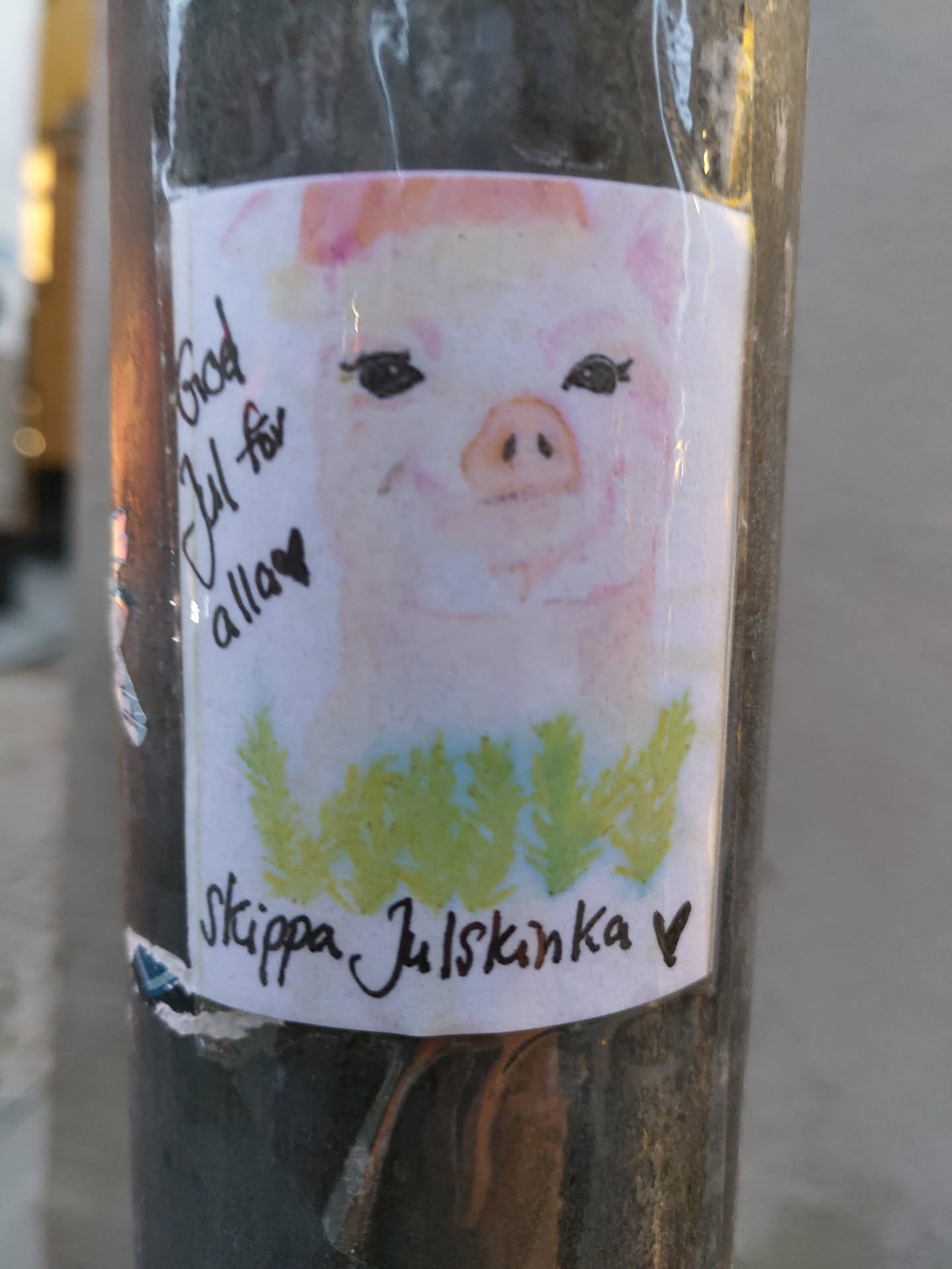 A sticker with a cute pig drawing and a message in Swedish. The text says "God Jul för alla" (Merry Christmas to all) and "Skippa Julskinka" (Skip the Christmas ham).
