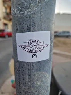 A square sticker with the text SUNOCOP in a logo that resembles the Nike Air Jordan wings logo. There is also an Instagram logo on the sticker.